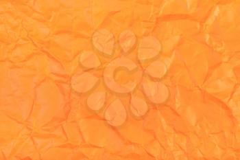 background from orange colour wrapping paper close up