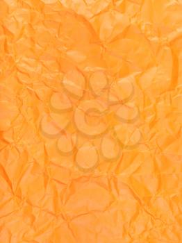 vertical background from orange colour crumpled paper