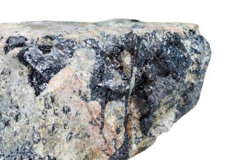 macro shooting of natural mineral stone - black Ilmenite ore in Nepheline (nephelite) stone isolated on white background