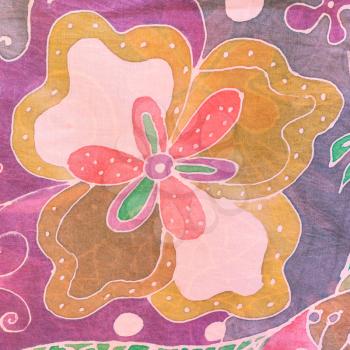 textile background - abstract hand painted flower on pink, brown and purple silk batik