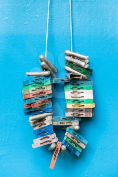 bunch of old clothespins on blue painted wall