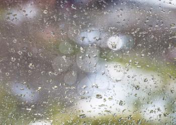 rain drops on windowpane and blurred urban background