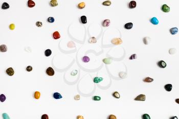 many natural mineral gem stones arranged on white background