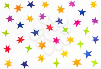 top view of various stars cut out from colored paper on white background