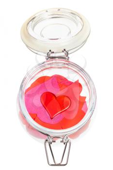 top view of one red heart on pile of hearts cut out from paper in open glass jar isolated on white background