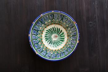 top view of traditional central asian bowl on dark brown table