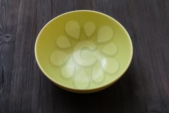 one green bowl on dark brown board