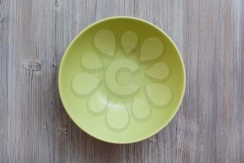 above view of one green bowl on gray brown table