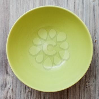 top view of one green bowl on gray brown table