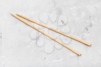 food concept - wooden disposable chopsticks (waribashi) on concrete board