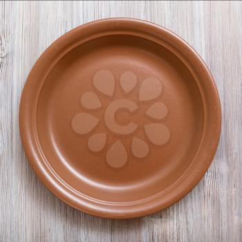 top view of one brown plate on gray brown table