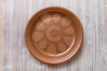 above view of one brown plate on gray brown table