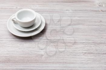 food concept - one white cup with saucers on gray brown table