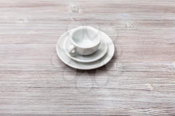 food concept - one white cup with saucers on gray brown board