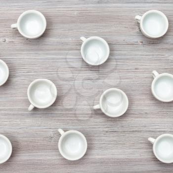 food concept - above view of several white cups on gray brown table