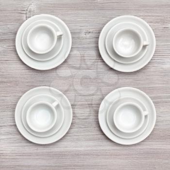 food concept - top view of four cups and saucers on gray brown board