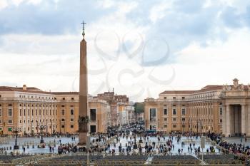 travel to Italy - Saint Peter's Square (Piazza San Pietro) with people and obelisk in Vatican city in evening