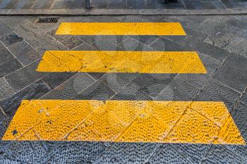 travel to Italy - yellow stripes crosswalk across the street in Florence city