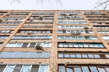 facade of multistory brick urban house in winter day