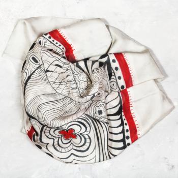 hand painted silk head scarf on concrete plate