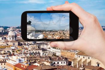travel concept - tourist photographs Rome city skyline on smartphone in Italy