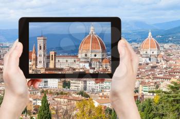 travel concept - tourist photographs Basilica Duomo Santa Maria del Fiore in Florence city on tablet in Italy