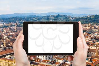 travel concept - tourist photographs Florence city on tablet with cut out screen with blank place for advertising in Italy
