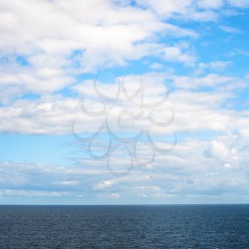 low white clouds in blue sky over Baltic Sea in autumn day