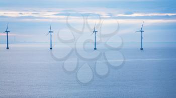 Travel to Denmark - calm water of Baltic Sea with offshore wind farm Middelgrunden in Oresund near Copenhagen city in blue autumn morning