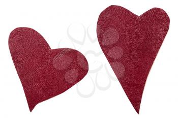 two red leather hearts isolated on white background