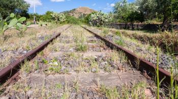 travel to Italy - abandoned country railroad in Sicily in summer day