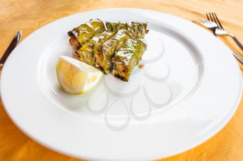travel to Italy, italian cuisine - local sicilian antipasi lemon leaf meatballs on white plate in Sicily