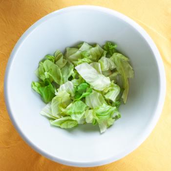 travel to Italy, italian cuisine - top view of portion of green lettuce in white bowl in Sicily