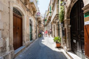 SYRACUSE, ITALY - JULY 3, 2011: people on street Via Cavour in Syracuse city. The city is a historic town in Sicily, the capital of the province of Syracuse.