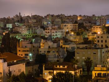 Travel to Middle East country Kingdom of Jordan - apartment houses in Amman city in night
