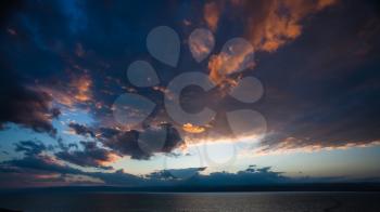 Travel to Middle East country Kingdom of Jordan - sundown in dark clouds over Dead Sea in winter evening