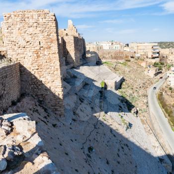 Travel to Middle East country Kingdom of Jordan - view of outer wall of medieval Kerak castle and urban houses of Al-Karak town