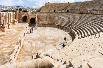 JERASH, JORDAN - FEBRUARY 18, 2012: tourists in Large South Theatre in winter. Greco-Roman town Gerasa (Antioch on the Golden River) was founded by Alexander the Great or his general Perdiccas