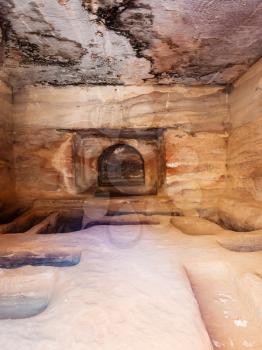 PETRA, JORDAN - FEBRUARY 21, 2012: interior of ancient tomb in Petra town. Rock-cut town Petra was established about 312 BC as the capital city of the Arab Nabataean