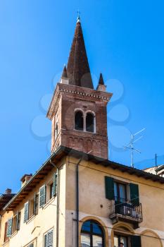 travel to Italy - tower of chiesa di San Tomaso Becket (chiesa di San Tomaso Cantuariense) over urban house in Verona city in spring