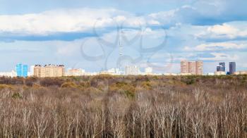 view of urban park and Moscow skyline with TV tower in early spring