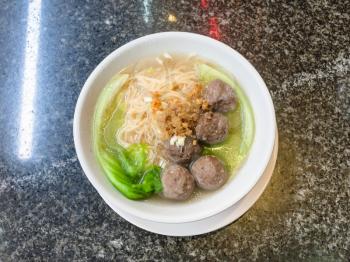 travel to China - top view of meatballs with noodle soup in bowl on table in chinese cafe in Yangshuo town County