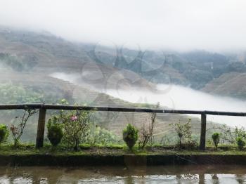 travel to China - view of cloud in valley between terraced hills from Tiantouzhai village in area Dazhai Longsheng Rice Terraces (Dragon's Backbone terrace, Longji Rice Terraces) country in spring