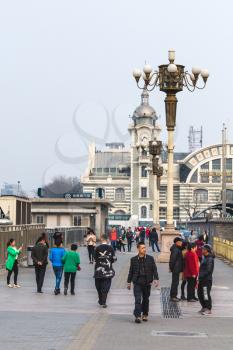 BEIJING, CHINA - MARCH 19, 2017: people near Zhengyangmen East Railway Station, branch of the China Railway Museum on Qianmen street. This building was opened as Beijing Railway Museum in 2008