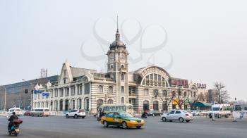 BEIJING, CHINA - MARCH 19, 2017: cars on square and Zhengyangmen East Railway Station, part of the China Railway Museum on Qianmen street. This building was opened as Beijing Railway Museum in 2008