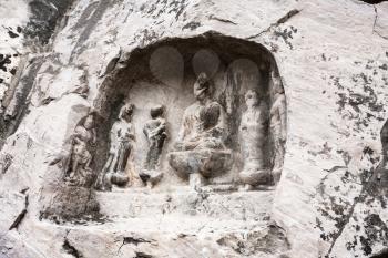 LUOYANG, CHINA - MARCH 20, 2017: relief figures in cave in West Hill of Chinese Buddhist monument Longmen Grottoes. The complex was inscribed upon the UNESCO World Heritage List in 2000