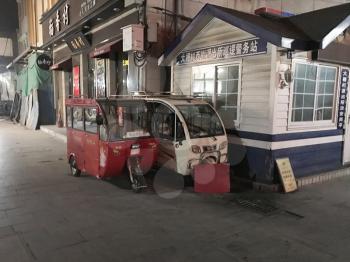 BEIJING, CHINA - MARCH 19, 2017: urban transport in Hutong Area around Dashilan and Liu Lichang streets in old town in night. Hutongs are narrow streets protected to preserve Chinese cultural history
