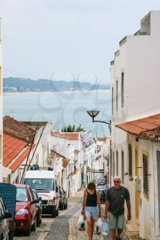 LAGOS, PORTUGAL - JUNE 18, 2006: people on the coastal street in old town of Lagos. Lagos is one of the most visited cities in the Algarve and Portugal due to its Atlantic Ocean beaches