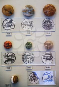 ATHENS, GREECE - SEPTEMBER 12, 2007: ancient carved seals in National Archaeological Museum. The museum is house some of the important artifacts from archaeological locations around Greece