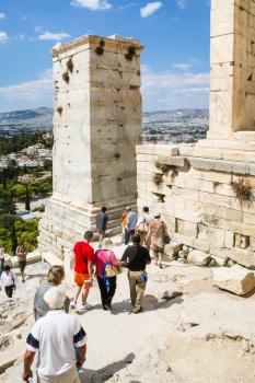 ATHENS, GREECE - SEPTEMBER 9, 2007: tourists near Propylaea of the Athenian Acropolis in Athens. Acropolis of Athens is ancient citadel located on rock above the city